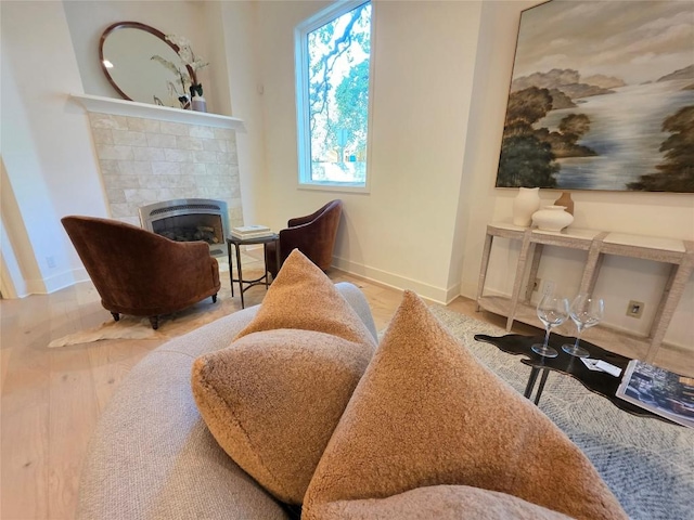 3007 Windsor Rd Unit B, Austin, TX 78703 - sitting room featuring a tiled fireplace, baseboards, and wood finished floors