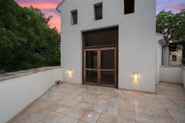 3007 Windsor Rd Unit B, Austin, TX 78703 - back of house at dusk with stucco siding and a patio