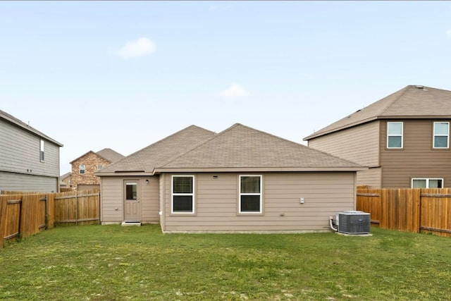 18720 Speculator Ln, Elgin, TX 78621 - back of house with cooling unit, a yard, and a fenced backyard