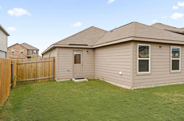 18720 Speculator Ln, Elgin, TX 78621 - rear view of property featuring a yard, roof with shingles, and fence