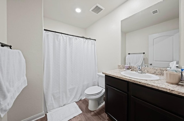 18720 Speculator Ln, Elgin, TX 78621 - full bathroom featuring curtained shower, toilet, visible vents, and wood finished floors