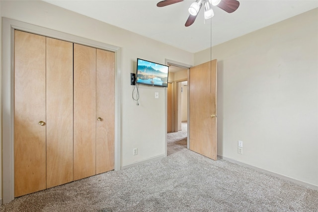 unfurnished bedroom with a closet, baseboards, ceiling fan, and carpet floors
