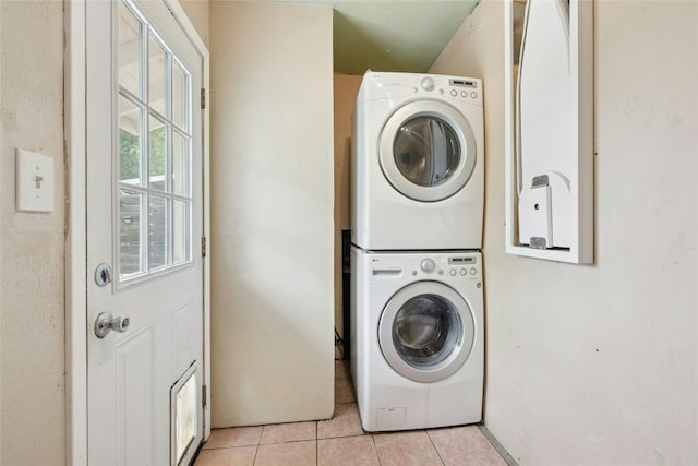 7000 Miranda Dr, Austin, TX 78752 - laundry area with stacked washer / dryer and light tile patterned floors