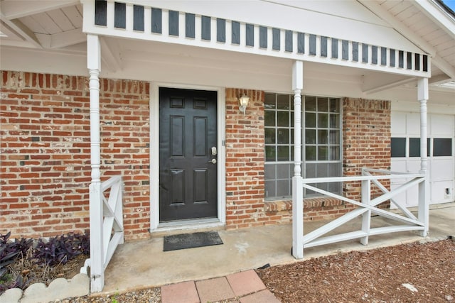 7000 Miranda Dr, Austin, TX 78752 - doorway to property with brick siding, a porch, and a garage