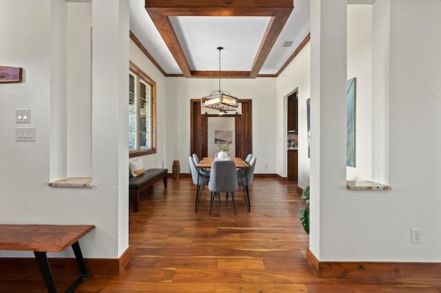21216 Bertram Ln, Spicewood, TX 78669 - dining space featuring a chandelier, wood finished floors, baseboards, and a raised ceiling