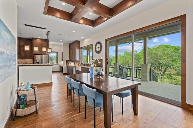21216 Bertram Ln, Spicewood, TX 78669 - dining room featuring coffered ceiling, light wood-style flooring, beamed ceiling, recessed lighting, and baseboards