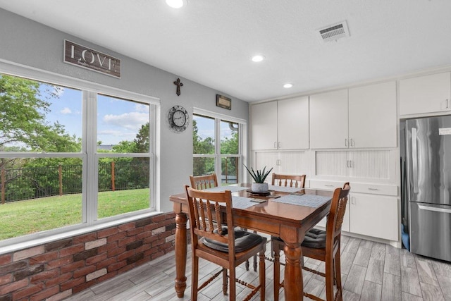 5315 Denmans Loop, Belton, TX 76513 - dining area with light wood-type flooring, visible vents, brick wall, and recessed lighting