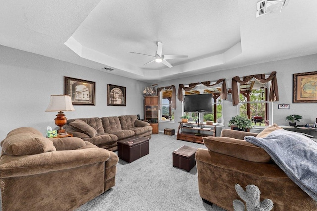 5315 Denmans Loop, Belton, TX 76513 - carpeted living area with a tray ceiling, a ceiling fan, and visible vents