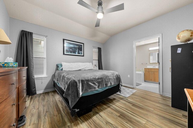 5315 Denmans Loop, Belton, TX 76513 - bedroom with baseboards, vaulted ceiling, ensuite bath, and wood finished floors
