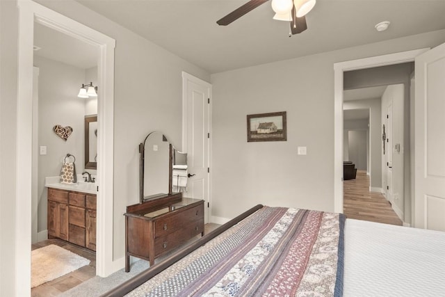 413 Creekside Dr, Salado, TX 76571 - bedroom featuring light wood-type flooring, ensuite bathroom, baseboards, and ceiling fan
