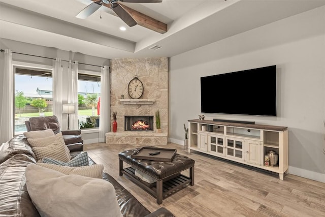413 Creekside Dr, Salado, TX 76571 - living room with wood finished floors, visible vents, a ceiling fan, baseboards, and a stone fireplace