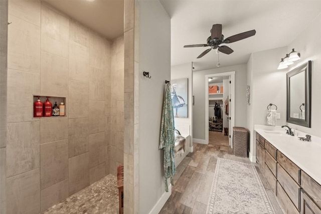 413 Creekside Dr, Salado, TX 76571 - bathroom with walk in shower, wood finished floors, vanity, ceiling fan, and baseboards