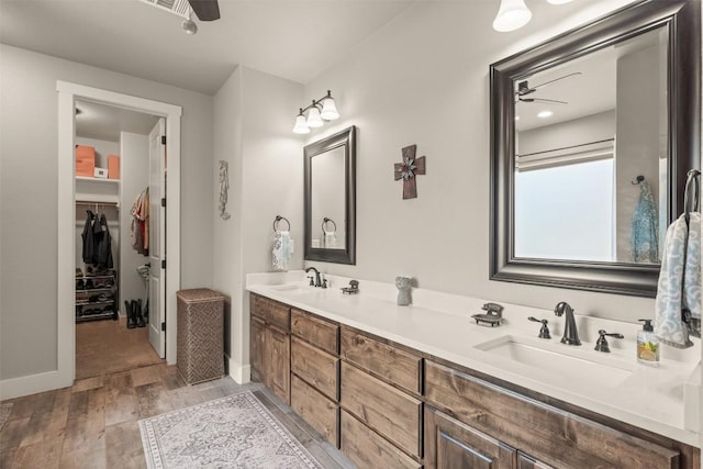 413 Creekside Dr, Salado, TX 76571 - bathroom with a ceiling fan, a sink, and wood finished floors