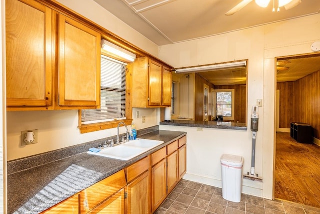 1226 Saint Matthew St, Gonzales, TX 78629 - kitchen with brown cabinets, dark countertops, ceiling fan, and a sink