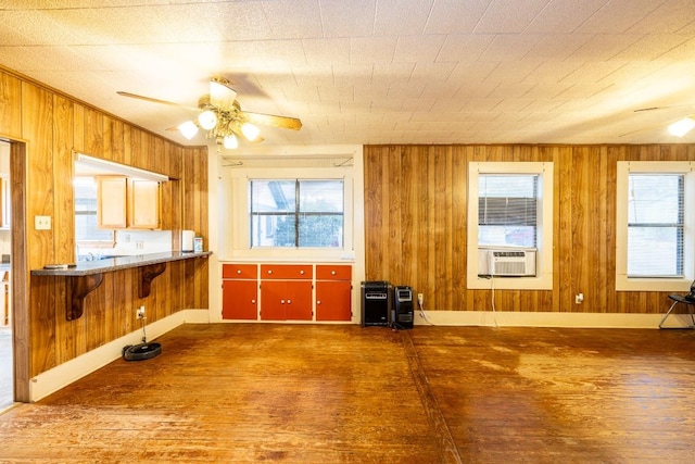 1226 Saint Matthew St, Gonzales, TX 78629 - kitchen featuring wood walls, wood finished floors, and ceiling fan