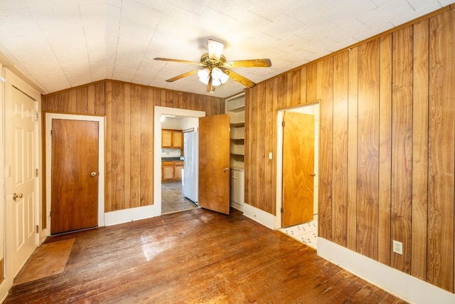 1226 Saint Matthew St, Gonzales, TX 78629 - interior space featuring a ceiling fan, wood walls, wood finished floors, and lofted ceiling