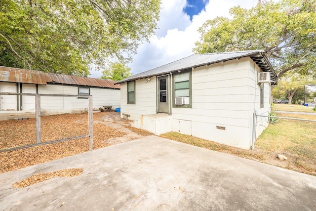 1226 Saint Matthew St, Gonzales, TX 78629 - view of front of property featuring a wall mounted air conditioner, crawl space, fence, metal roof, and a patio area