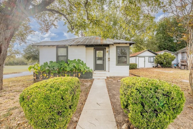 1226 Saint Matthew St, Gonzales, TX 78629 - bungalow-style house with an outbuilding, metal roof, and a storage unit