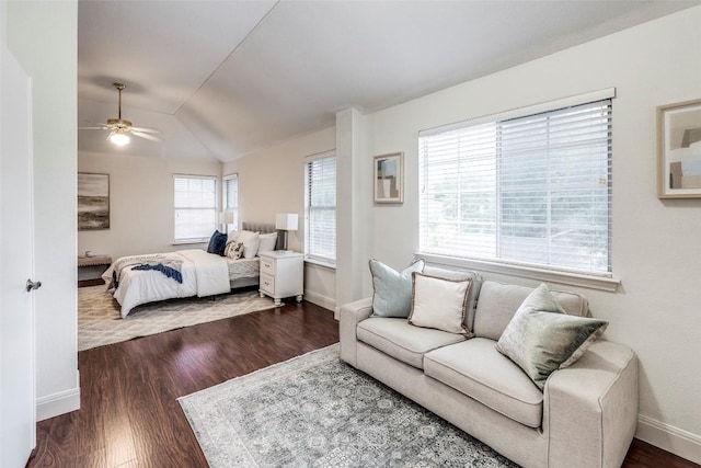 bedroom featuring baseboards, dark wood-style floors, and vaulted ceiling