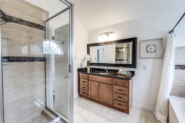 full bathroom featuring baseboards, tiled shower, tile patterned floors, vanity, and vaulted ceiling
