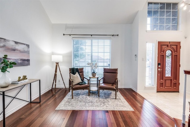 sitting room featuring a wealth of natural light, baseboards, and hardwood / wood-style flooring