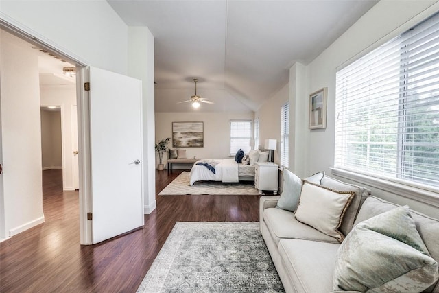 bedroom featuring lofted ceiling, dark wood-style flooring, and baseboards