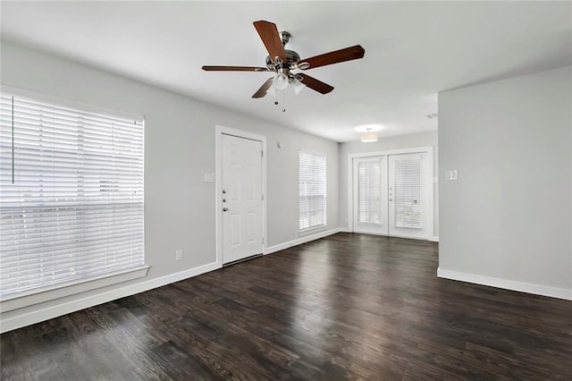 interior space with dark wood-style floors, baseboards, and a ceiling fan