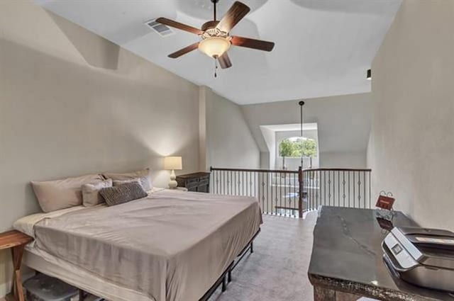 carpeted bedroom featuring vaulted ceiling, ceiling fan, and visible vents