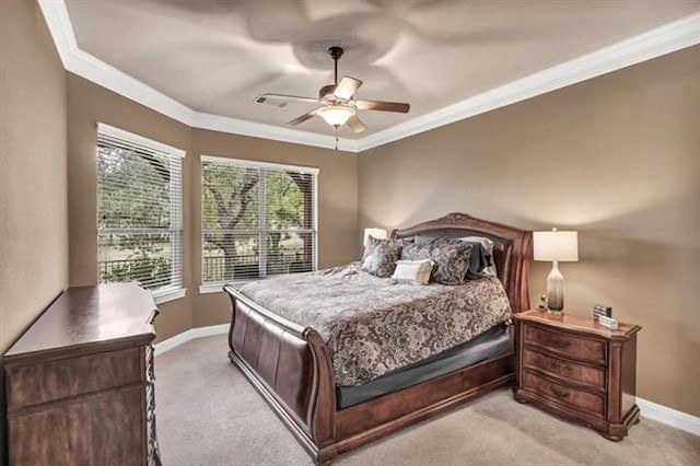 bedroom with light colored carpet, crown molding, baseboards, and a ceiling fan