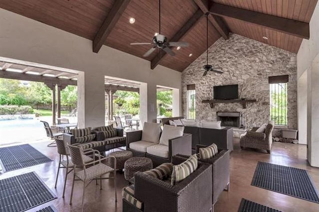 living room with a wealth of natural light, a ceiling fan, and wood ceiling