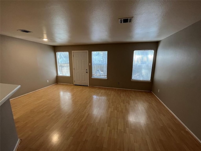 9625 Sugar Hill Dr, Austin, TX 78748 - unfurnished living room featuring baseboards, light wood-style flooring, and visible vents