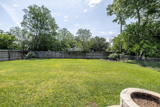 1338 Donovan St, Gonzales, TX 78629 - view of yard with a fire pit and a fenced backyard