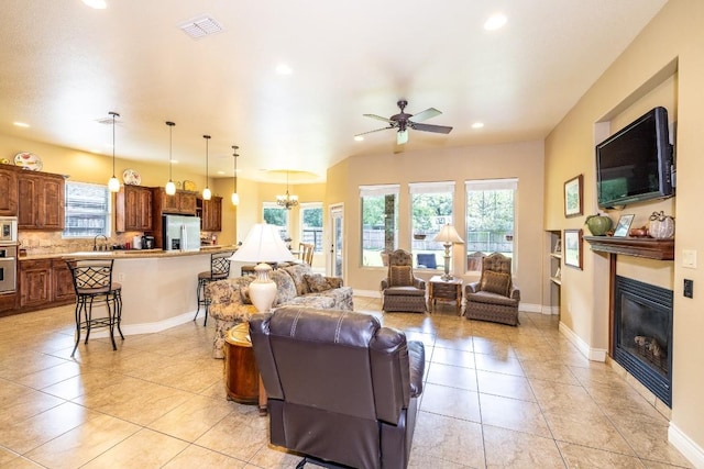 1338 Donovan St, Gonzales, TX 78629 - living room with recessed lighting, a wealth of natural light, visible vents, and a glass covered fireplace