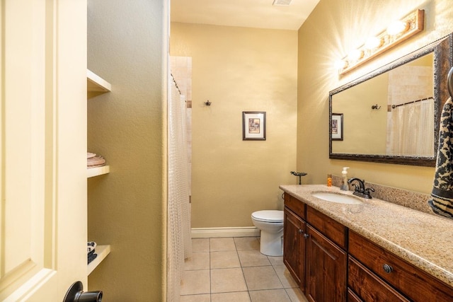 1338 Donovan St, Gonzales, TX 78629 - bathroom with tile patterned flooring, toilet, baseboards, and vanity