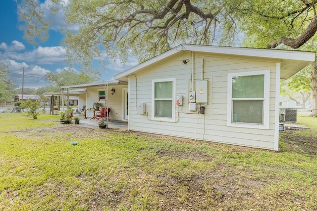 1318 Neuman St, Gonzales, TX 78629 - rear view of property with a patio, central AC unit, and a yard