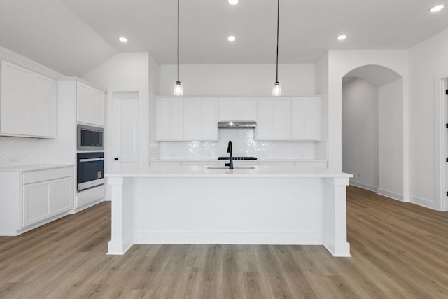 1108 Snowdrop Dr, Georgetown, TX 78628 - kitchen with appliances with stainless steel finishes, decorative backsplash, under cabinet range hood, light countertops, and recessed lighting