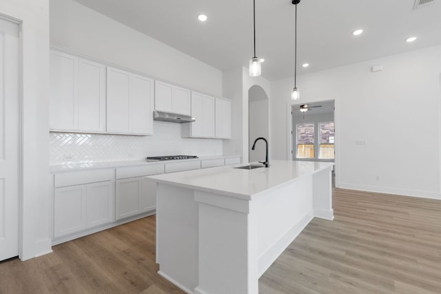 1108 Snowdrop Dr, Georgetown, TX 78628 - kitchen featuring light wood finished floors, decorative backsplash, ceiling fan, white cabinets, and recessed lighting