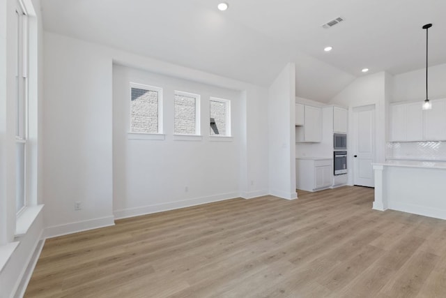 1108 Snowdrop Dr, Georgetown, TX 78628 - unfurnished living room featuring recessed lighting, vaulted ceiling, and light wood finished floors