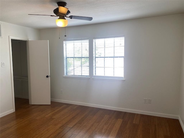 unfurnished bedroom featuring baseboards, ceiling fan, and wood finished floors