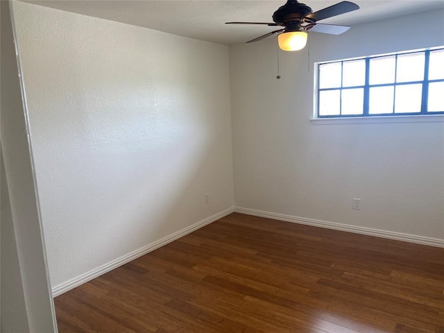 empty room with ceiling fan, baseboards, and wood finished floors