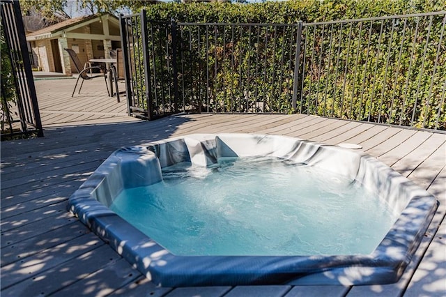 view of swimming pool with hot tub deck surround and a wooden deck