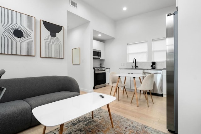 400 E 30th St Unit 200, Austin, TX 78705 - living room with light wood finished floors and recessed lighting