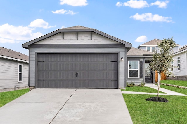 view of front of home with a front lawn, driveway, and a garage