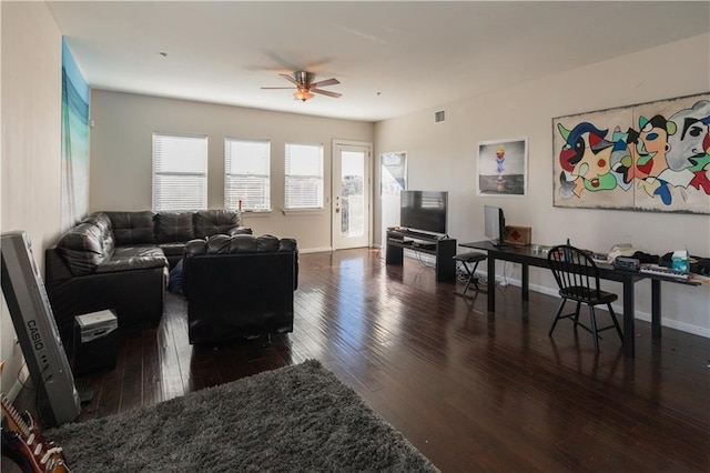 living area with a ceiling fan, baseboards, visible vents, and wood-type flooring