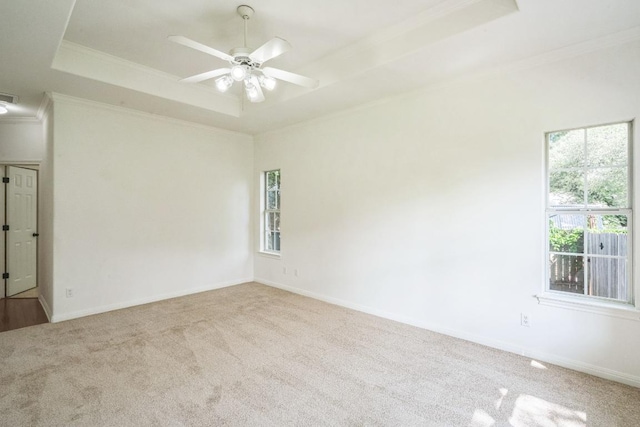 102 Ridgemont Ct, Georgetown, TX 78628 - carpeted empty room featuring a tray ceiling, ornamental molding, a ceiling fan, and baseboards