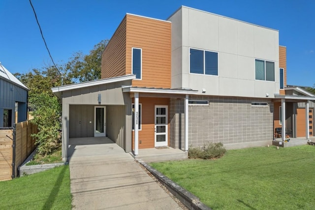 1210 Stobaugh St Unit B, Austin, TX 78757 - modern home featuring an attached carport, fence, a front lawn, board and batten siding, and driveway