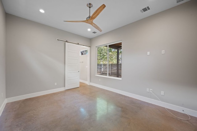 1210 Stobaugh St Unit B, Austin, TX 78757 - unfurnished room featuring a ceiling fan, a barn door, baseboards, finished concrete flooring, and visible vents