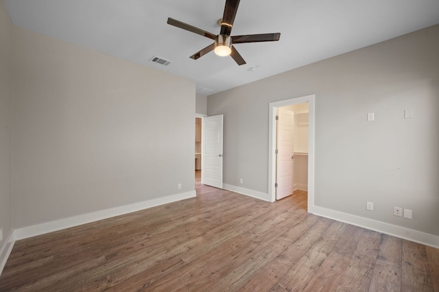 1210 Stobaugh St Unit B, Austin, TX 78757 - unfurnished bedroom featuring a closet, baseboards, visible vents, wood finished floors, and a spacious closet