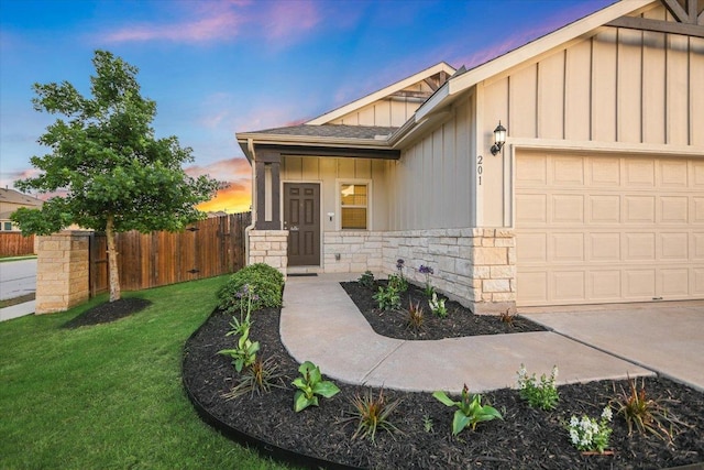 201 Cascata Way, Liberty Hill, TX 78642 - view of front of property featuring board and batten siding, an attached garage, and stone siding