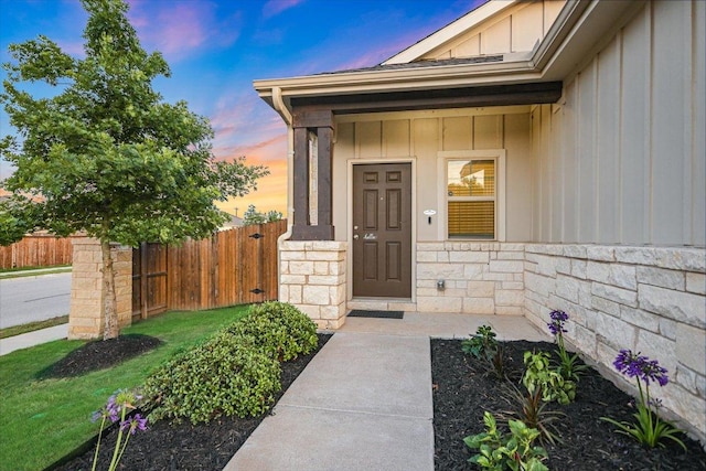 201 Cascata Way, Liberty Hill, TX 78642 - exterior entry at dusk with board and batten siding and stone siding